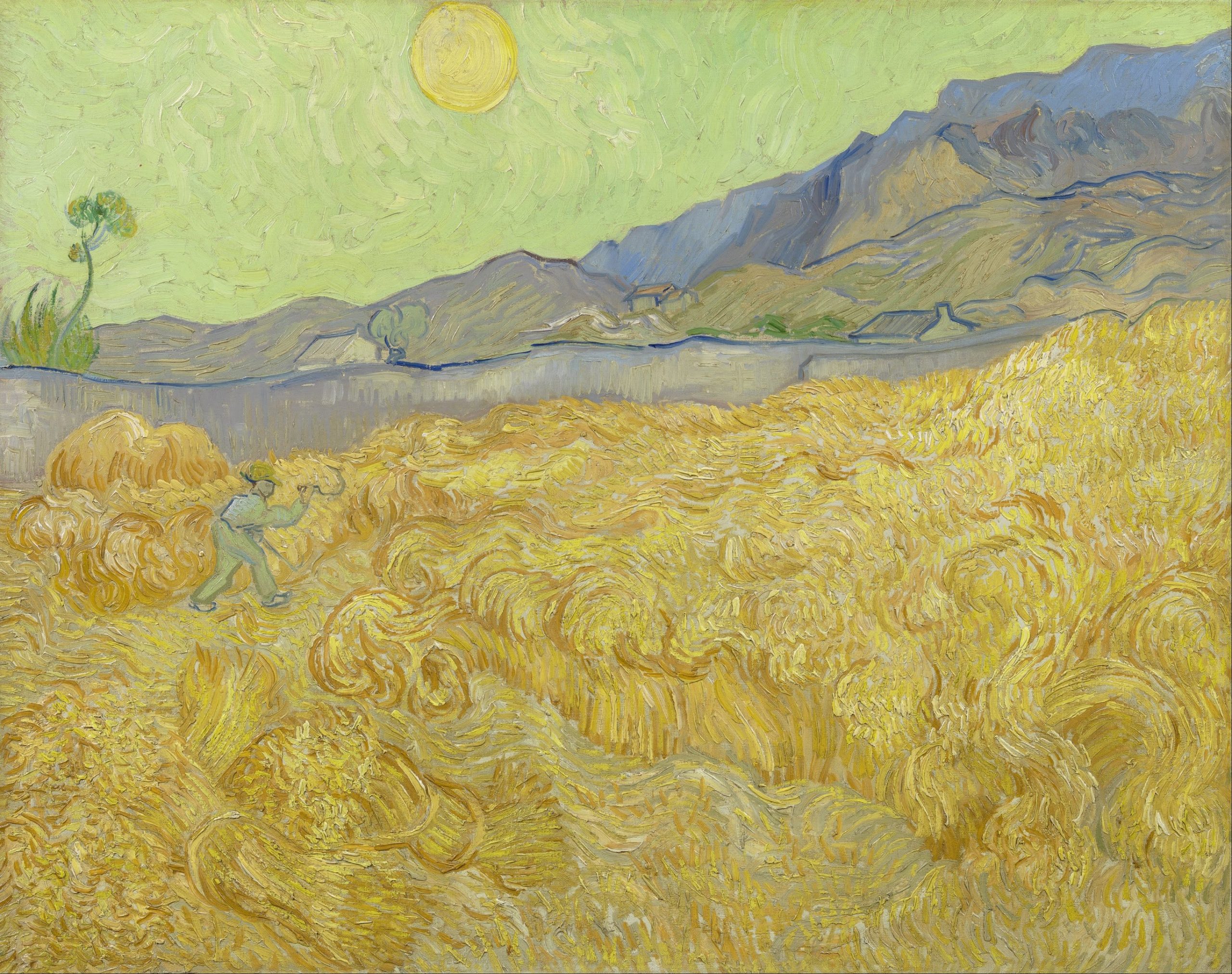 A landscape view of a wheatfield with a farmer harvesting crops