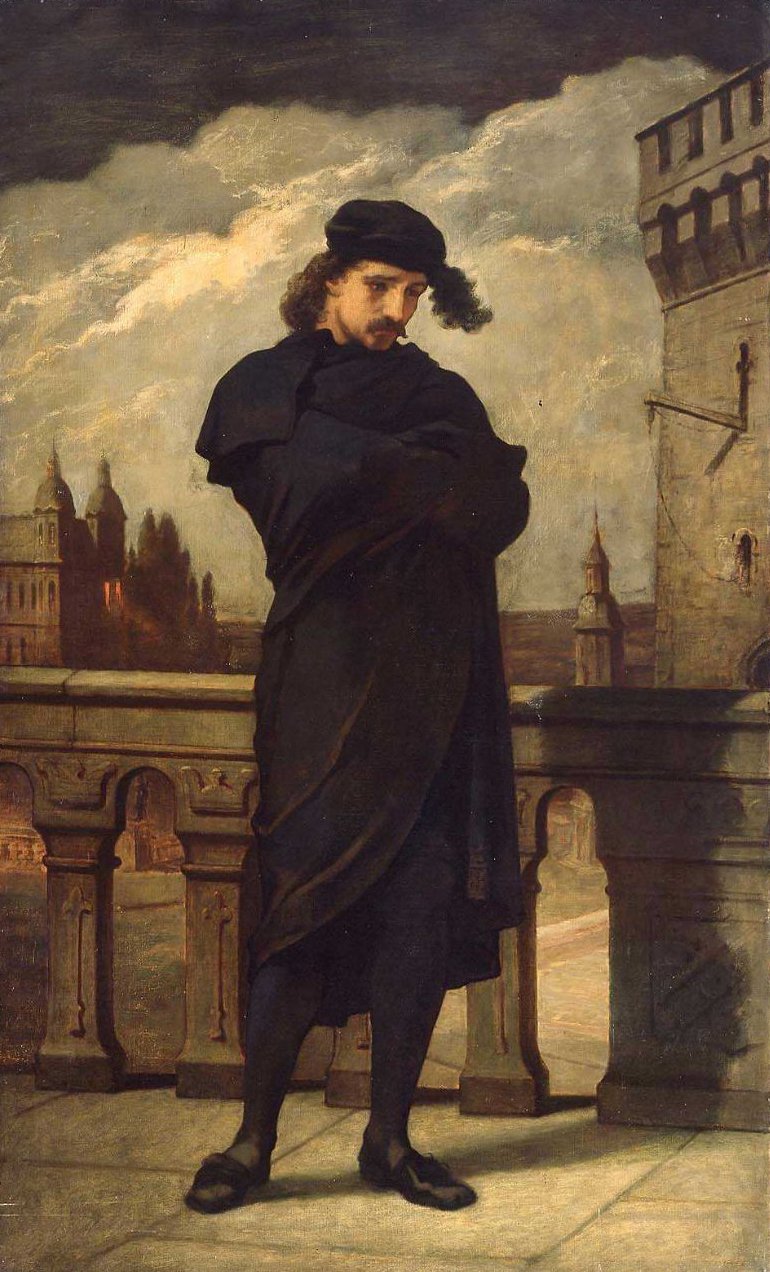 A man clothed in a black robe stands on a castle's walk way with his arms crossed as he stares towards the ground.