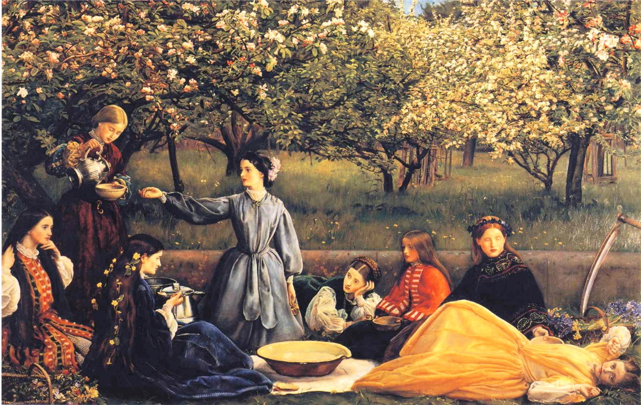 A group of women having refreshments at a blossoming apple orchard