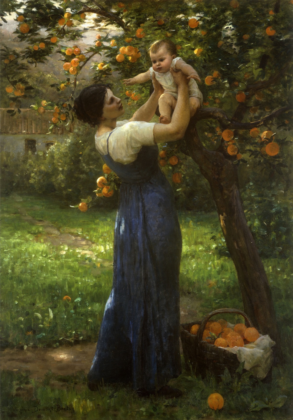 A mother holding up her infant child in an orange grove beside a tree with a basket of oranges at her feet