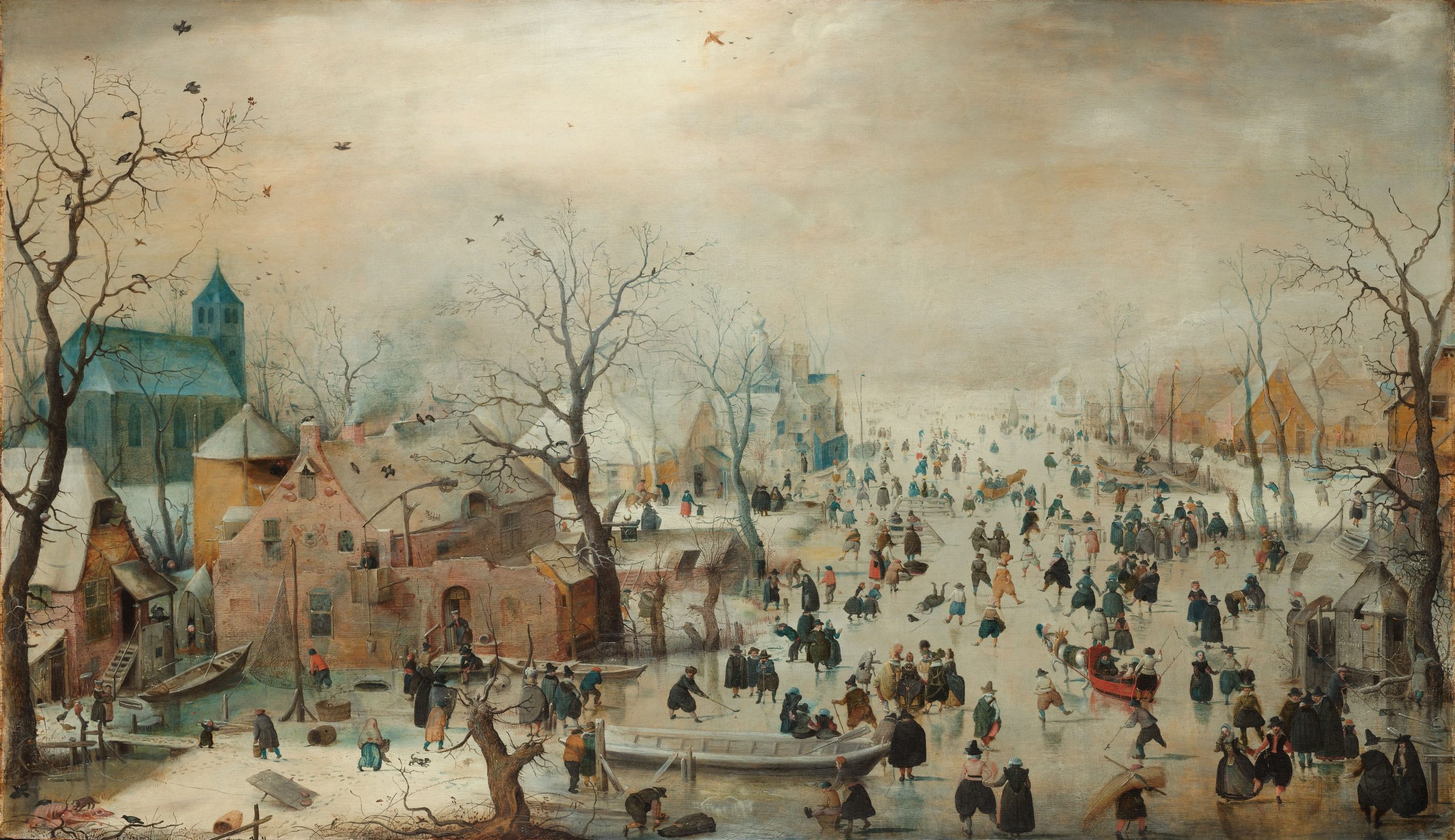 A winter landscape with people ice skating in a town
