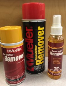 Three containers of tape remover spray.